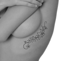 lower back tattoo - ivy with lilies