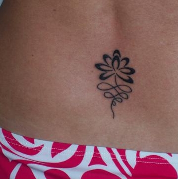 Claire - lotus lower back tattoo