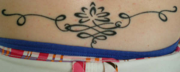 Tina - Lotus lower back tattoo photo